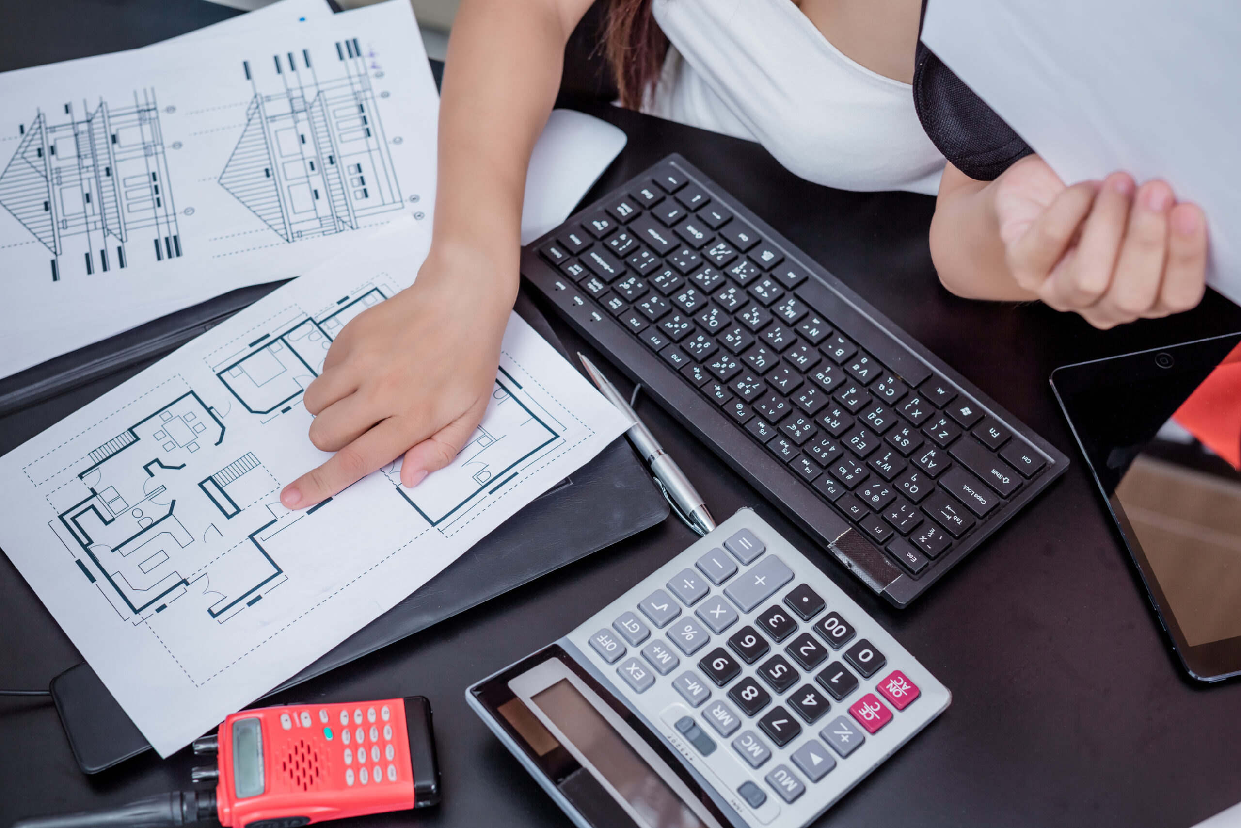 Services businesswoman working in the office with a smile while sitting.